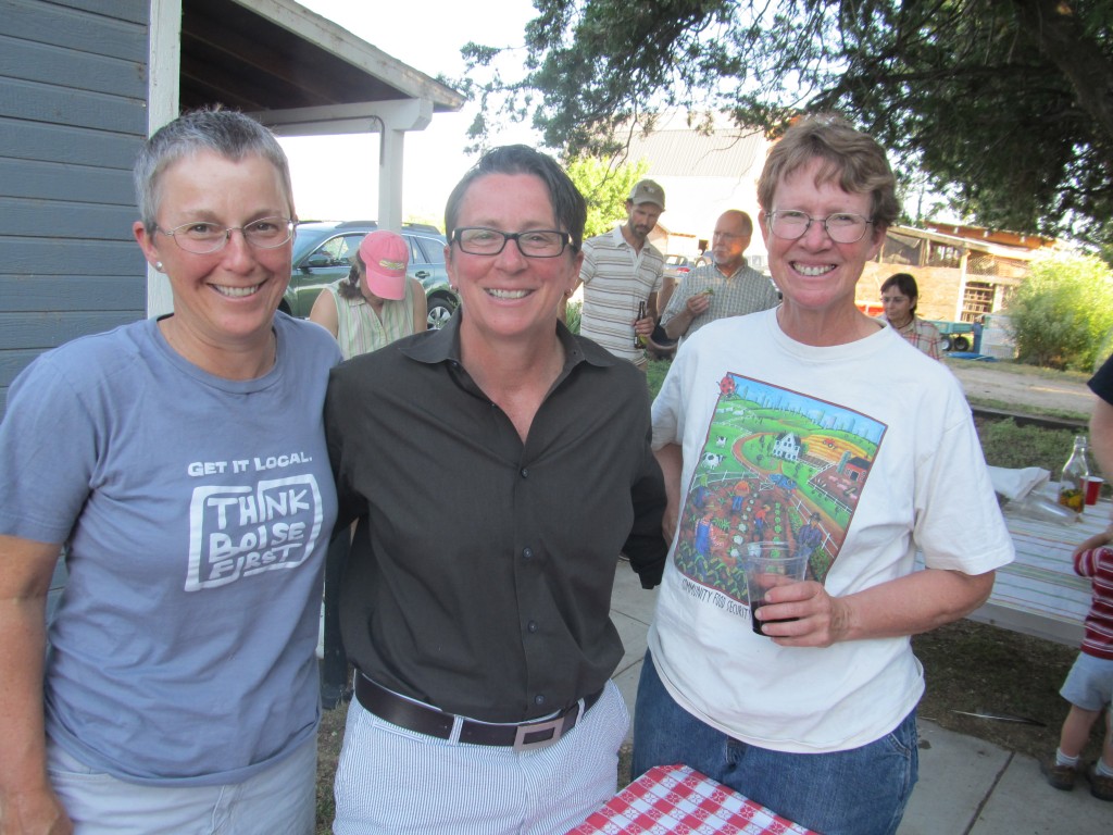 Pride Foundation ED Kris Hermanns shares a moment with Nampa, Idaho couple Lori Steele & Janie Burns, who hosted a Pride Foundation fundraiser at their farm in July.