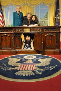 Linda and Carol with their granddaughters Katie and Emily (under the desk) at the White House