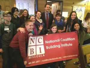 Governor Bullock posing with youth from Pride Foundation grantee, NCBI