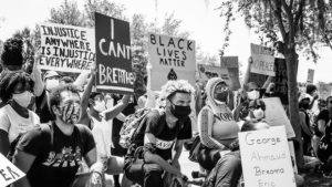 Black and white image of people protesting in support of Black Lives Matter, holding signs