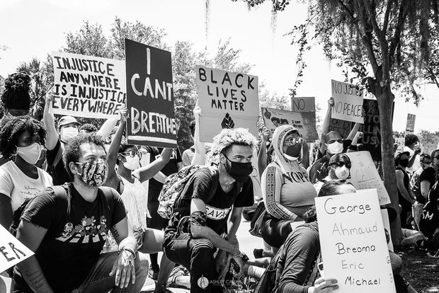 Black and white image of people protesting in support of Black Lives Matter, holding signs
